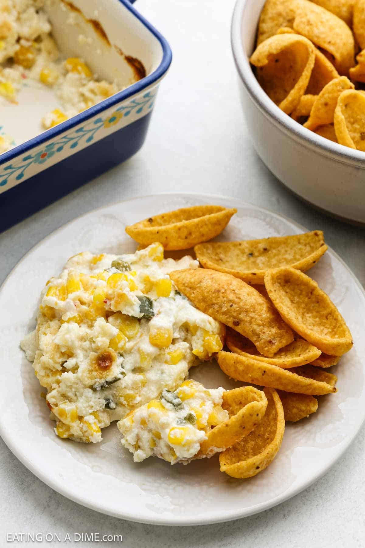 Serving corn dip with Fritos on a plate