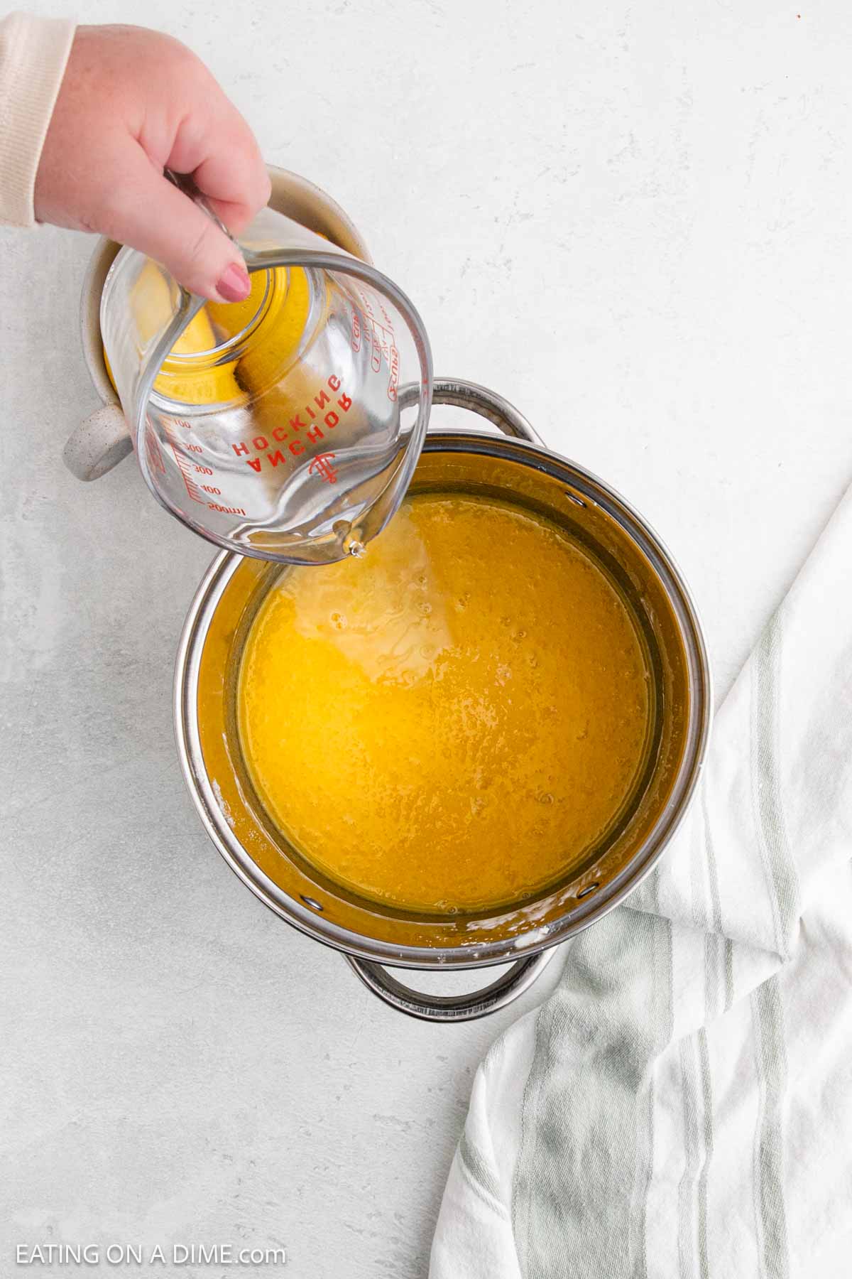 Pouring water into the lemon mixture into large pot
