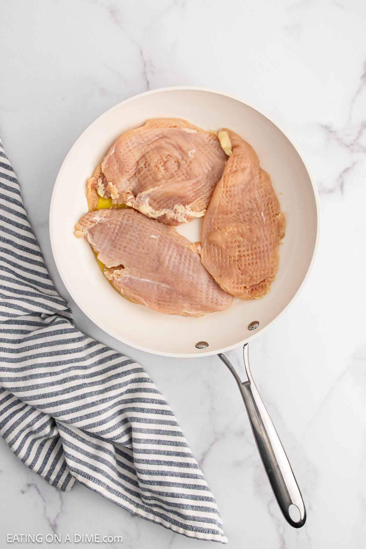 Pounded Chicken breast in a skillet