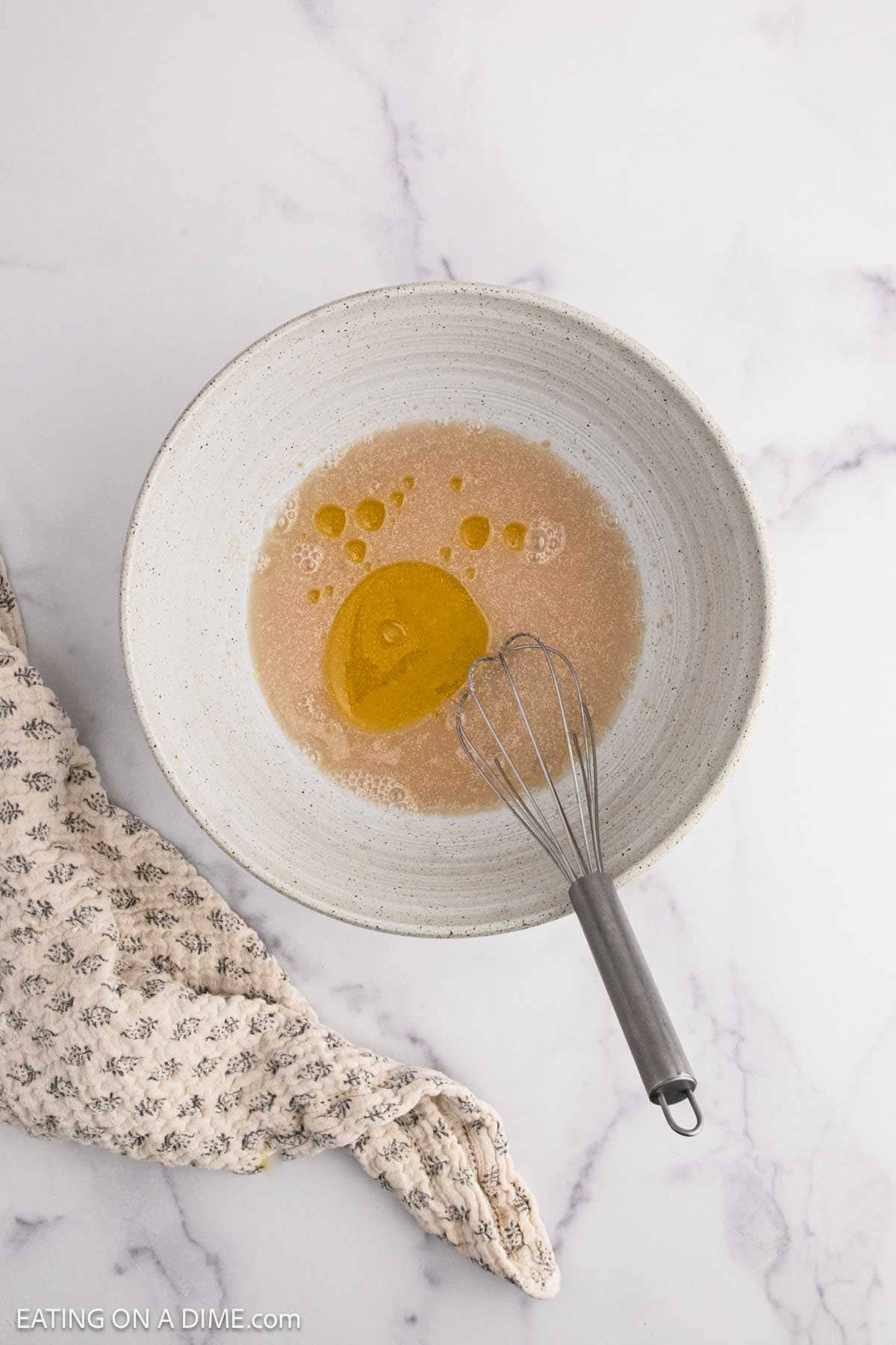 Combining the yeast, water, sugar, oil, and salt together
