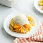 Peach cobbler with ice cream.