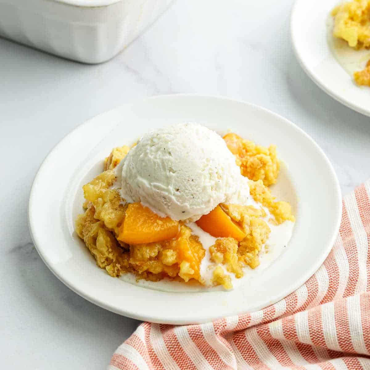 Peach cobbler with ice cream.