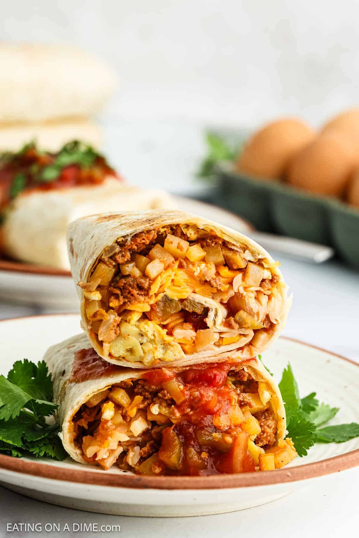 Chorizo Breakfast Burritos cut in half stacked on a plate
