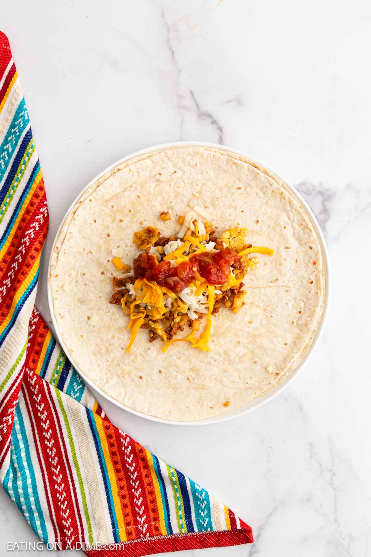 Layering the chorizo and egg mixture on the tortilla