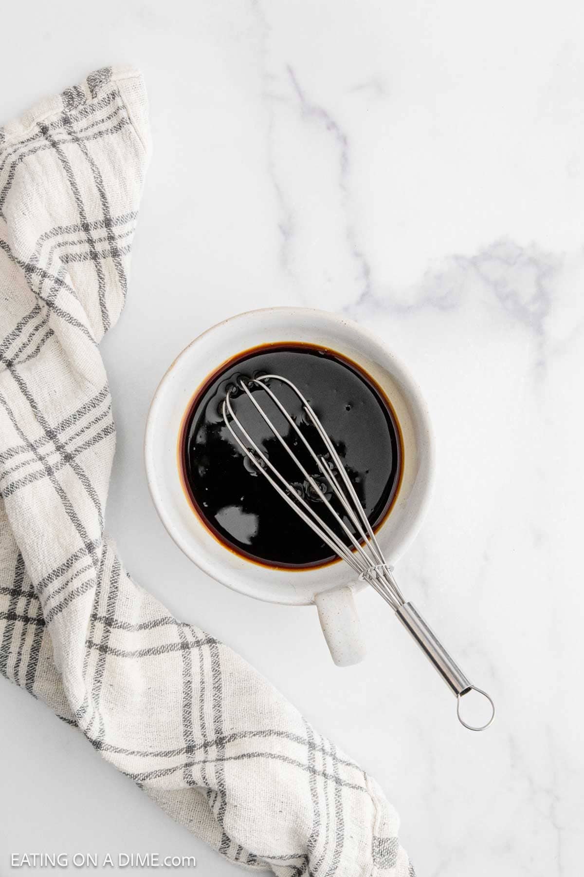 Combining the soy sauce mixture in a small bowl with a whisk