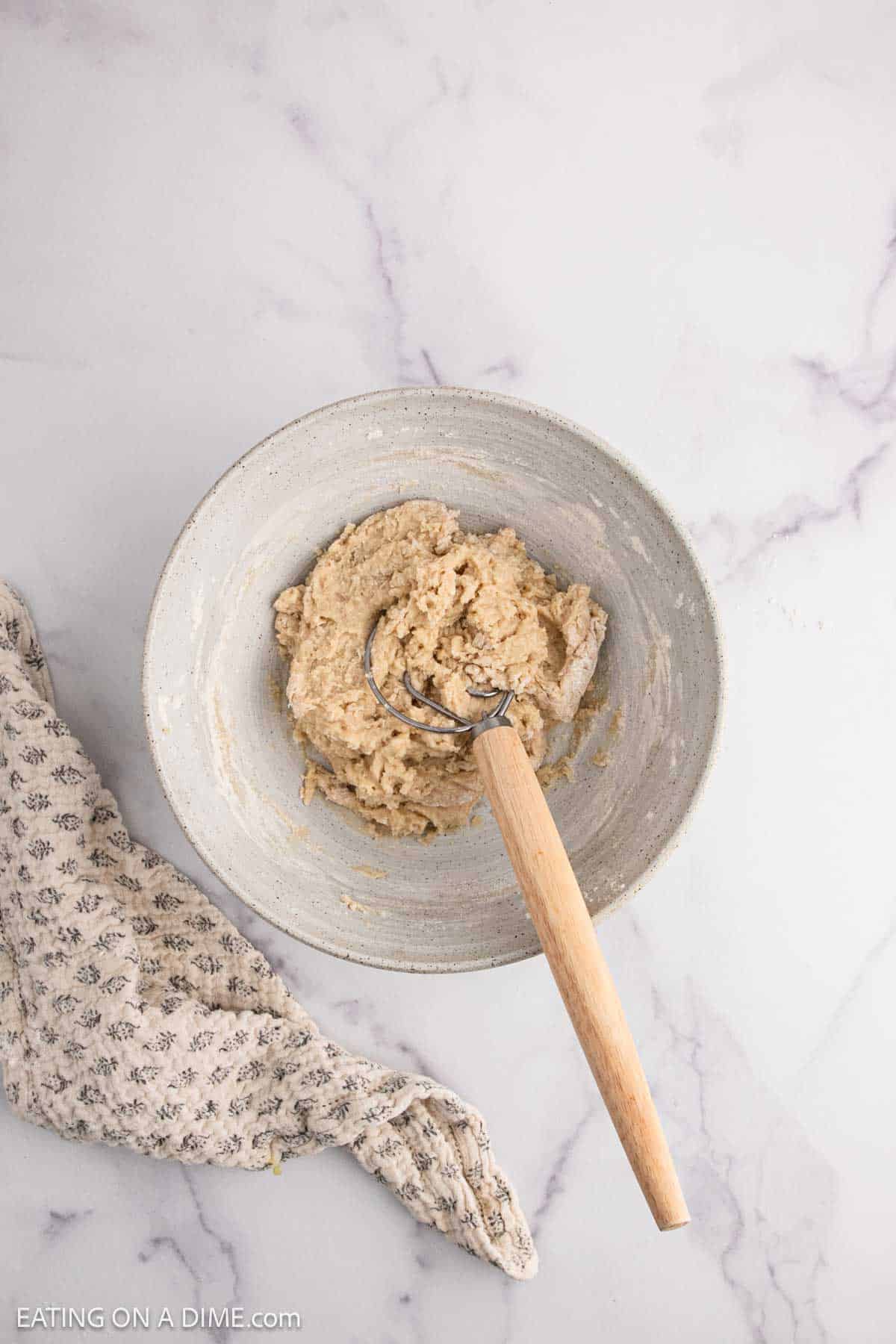 Mixing the dough together with a wooden spoon