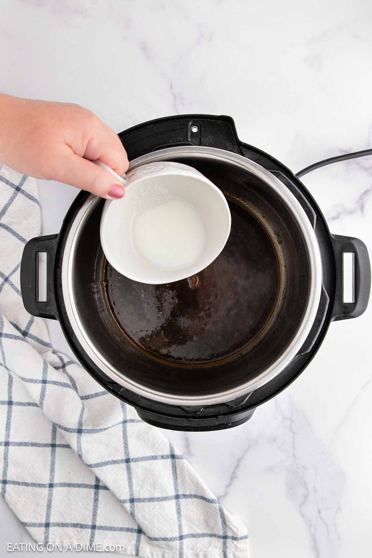 Pouring cornstarch slurry into instant pot