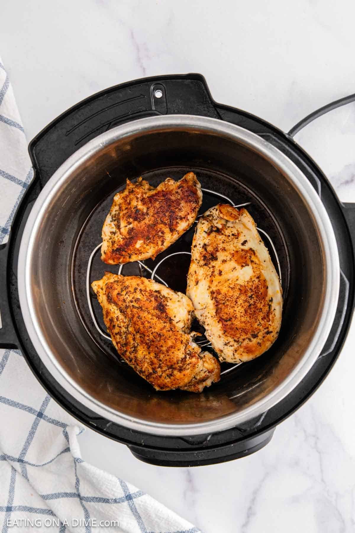 Golden brown chicken breast placed in the instant pot