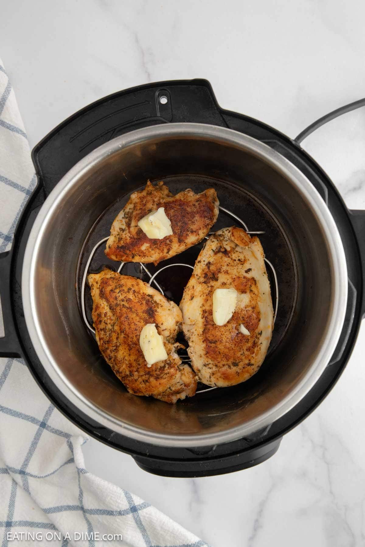 Topping chicken breast with butter