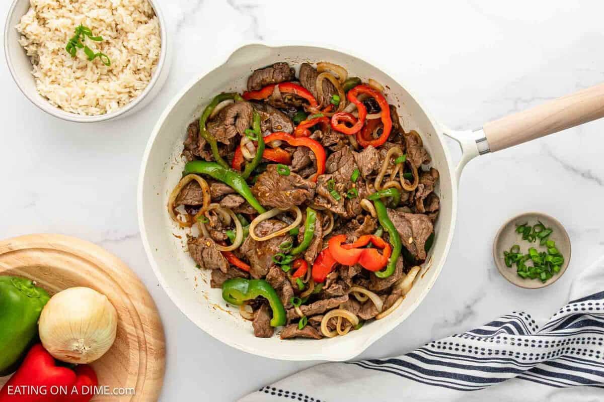 Beef Stir Fry in a skillet with red and green bell peppers