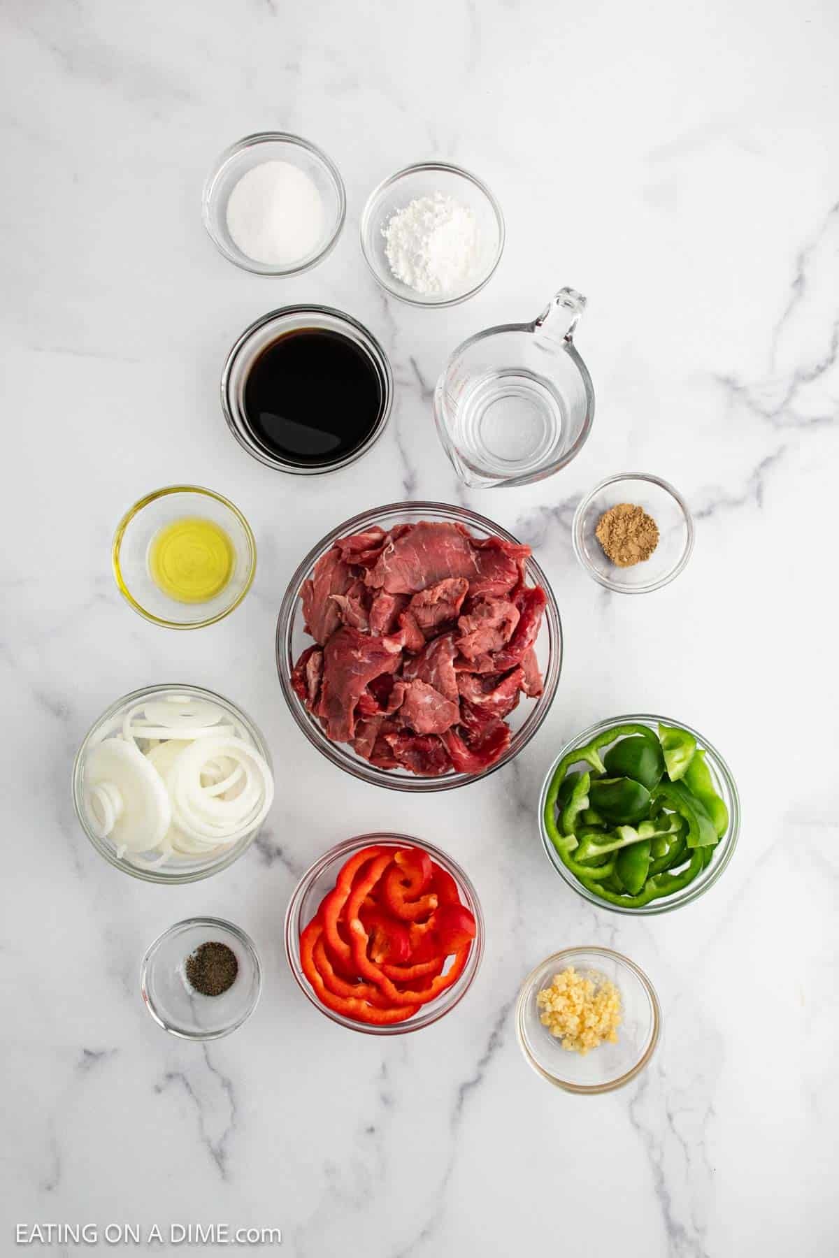 Ingredients - onion, red bell pepper, green bell pepper, olive oil, flank steak, pepper, ginger, minced garlic, soy sauce, sugar, cornstarch
