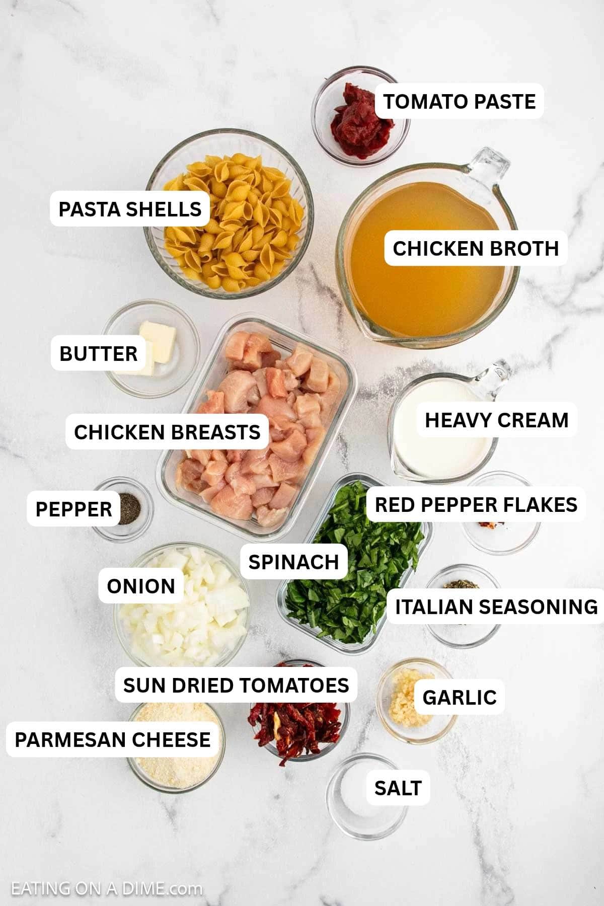 Ingredients for recipe: dry pasta shells, chicken broth, diced chicken, chopped spinach, cream, diced onions, shredded cheese, butter, tomato paste, garlic and spices.