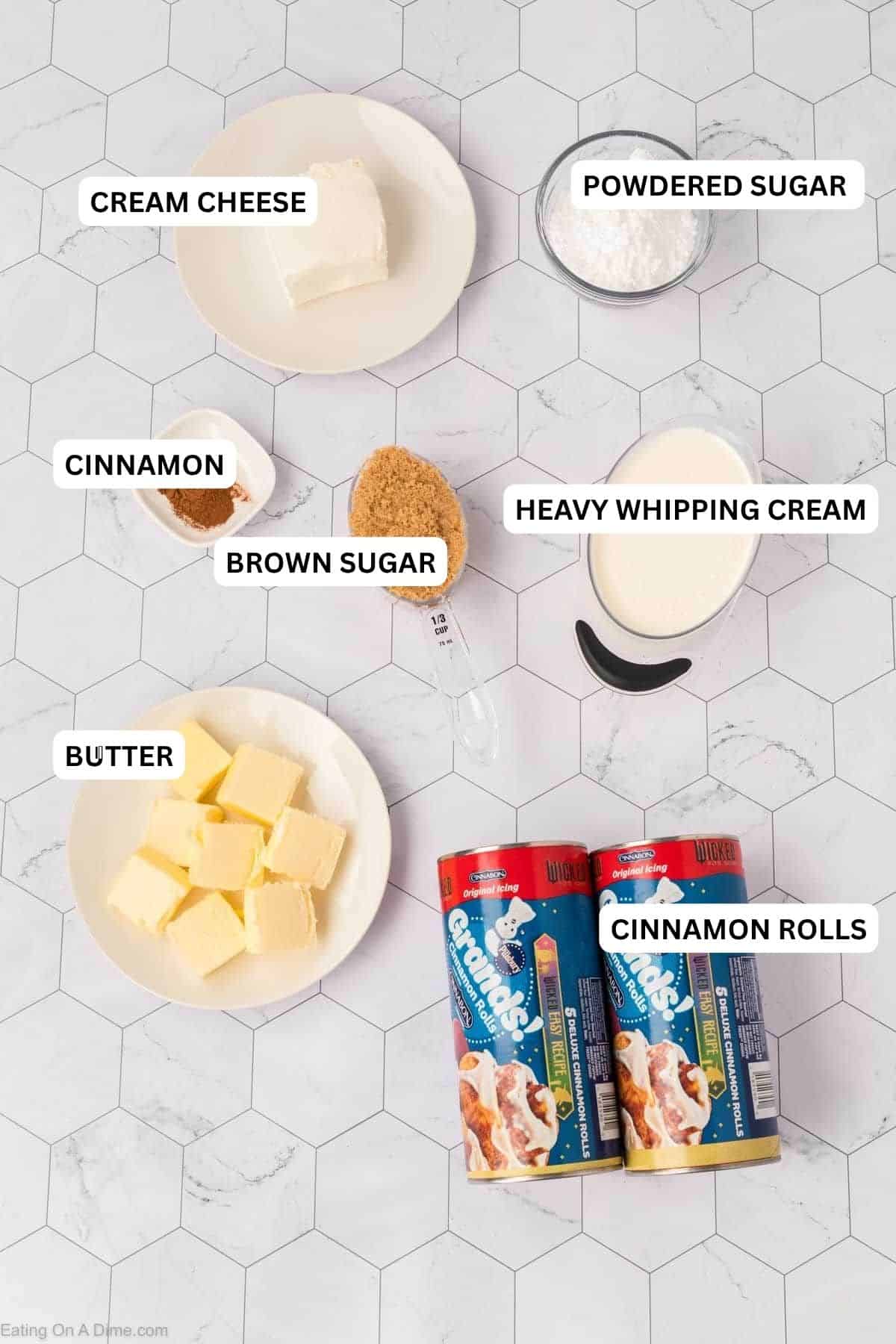 Ingredients recipe: cream cheese, powdered sugar, brown sugar, butter, cinnamon, heavy cream, and two cans of refrigerated cinnamon rolls.