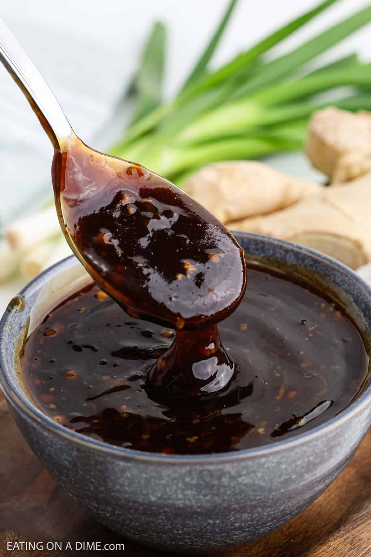 Sauce in a bowl with a serving of the sauce on a spoon.