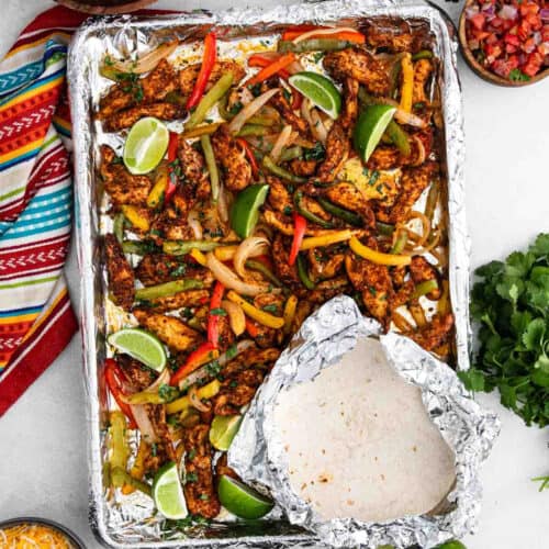 a pan of sheet pan chicken fajitas with tortillas