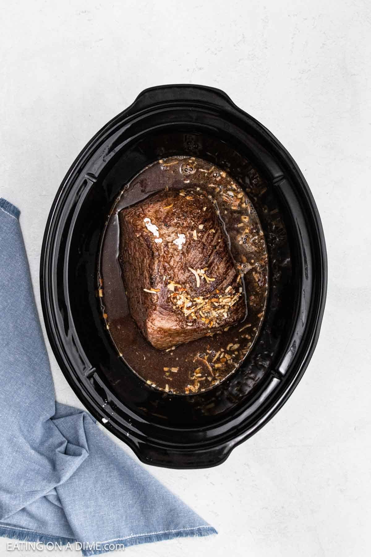 Seared roast in the crockpot with gravy and topped with onion soup mix.