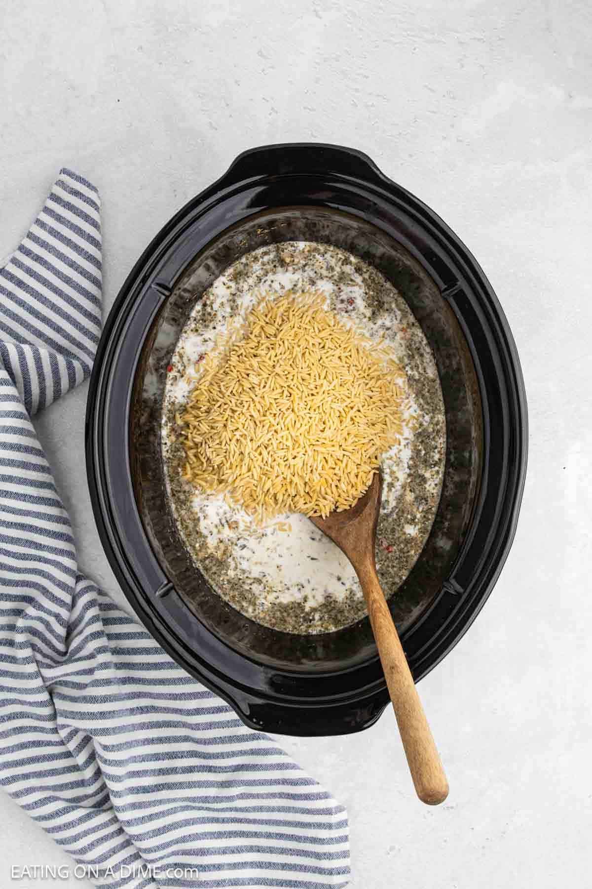 Orzo and heavy cream added to the cooked ingredients into the crock pot.