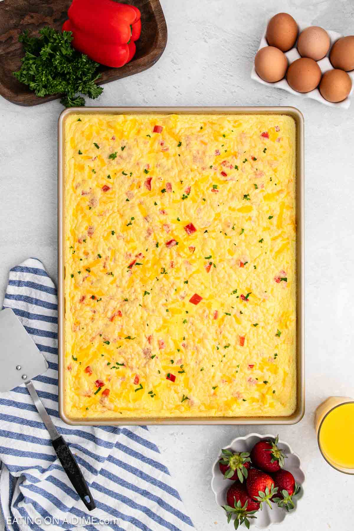 Baked eggs with red bell peppers in a sheet pan.