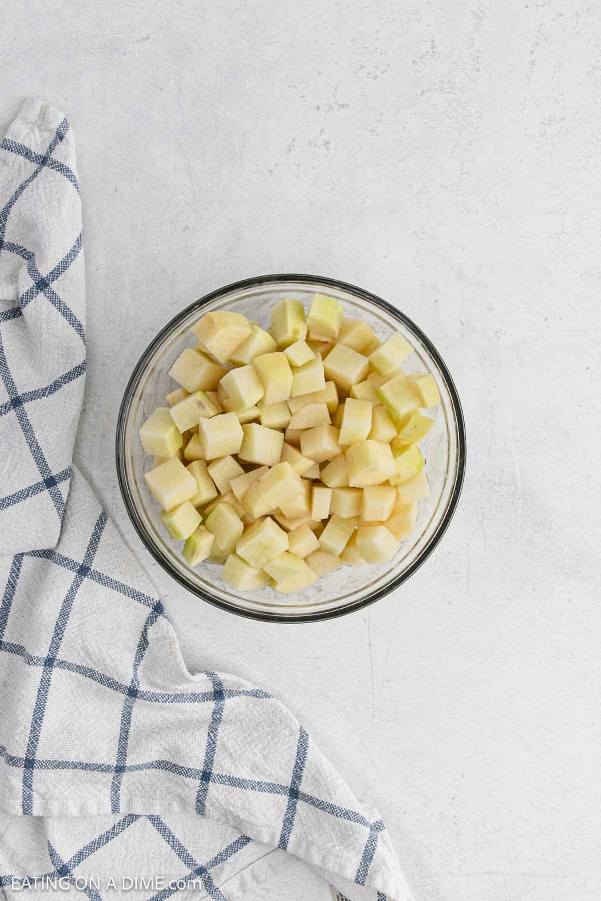 Diced and peeled potatoes in a bowl.