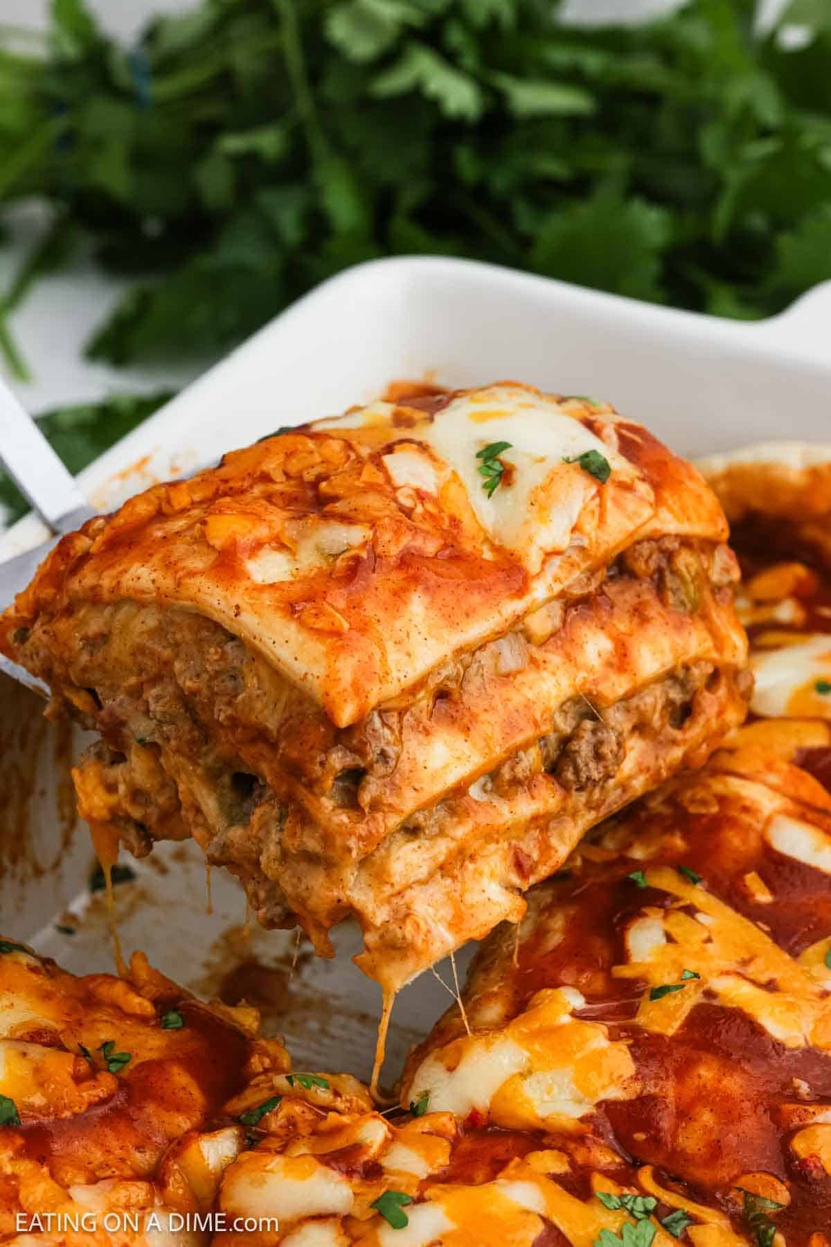 A serving of burrito casserole on a spatula ready to serve.