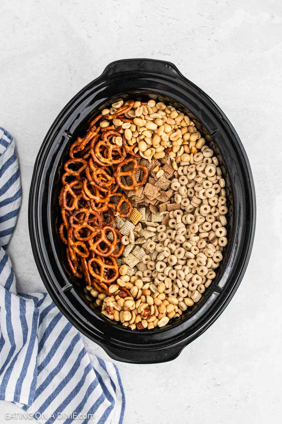 Add the chex mix ingredients into the slow cooker.
