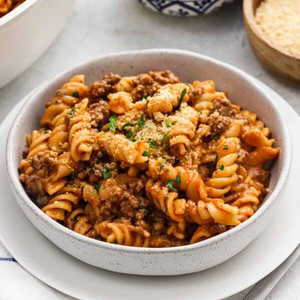 A serving of beef and rotini pasta in a bowl.