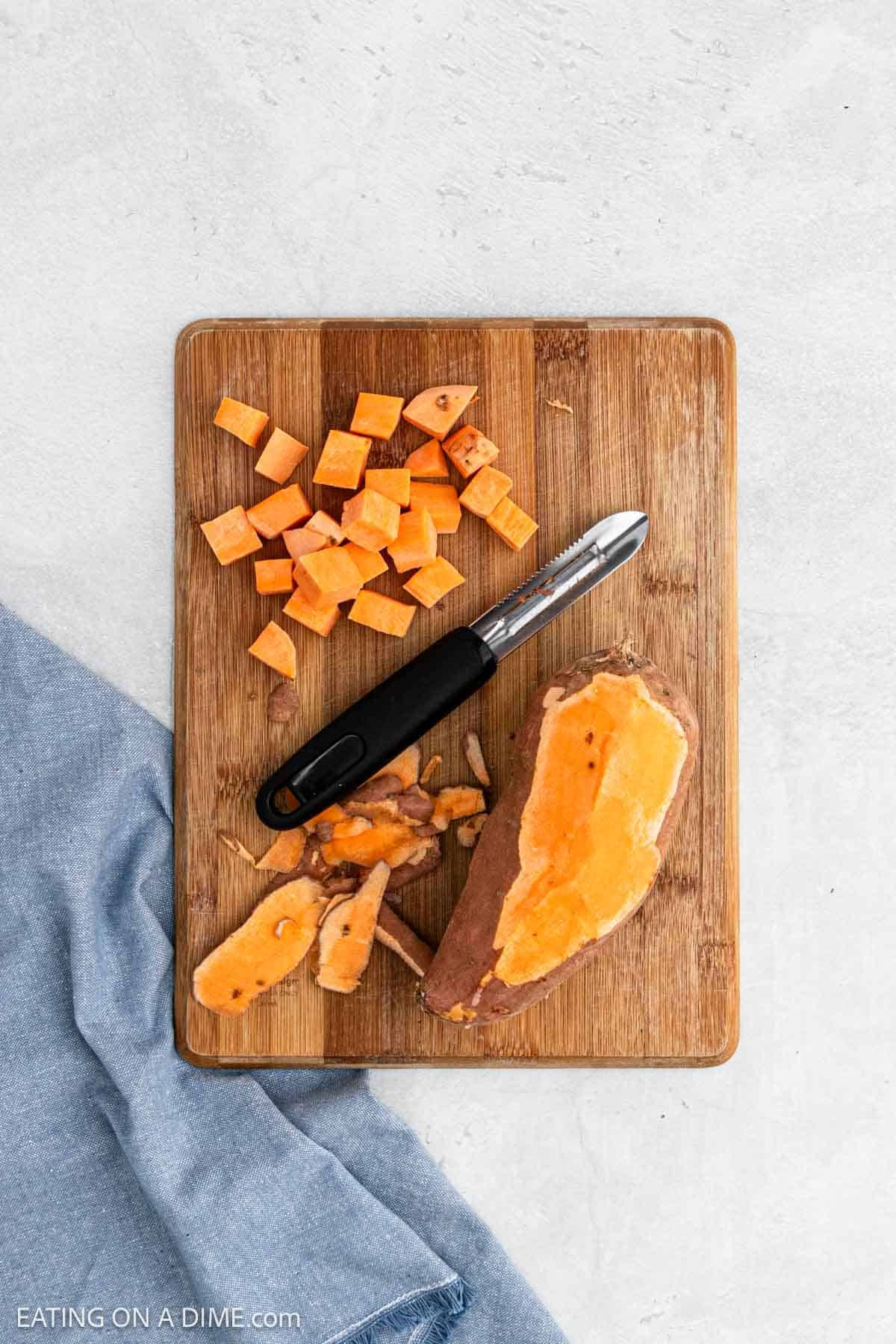 Diced sweet potatoes on a cutting board.