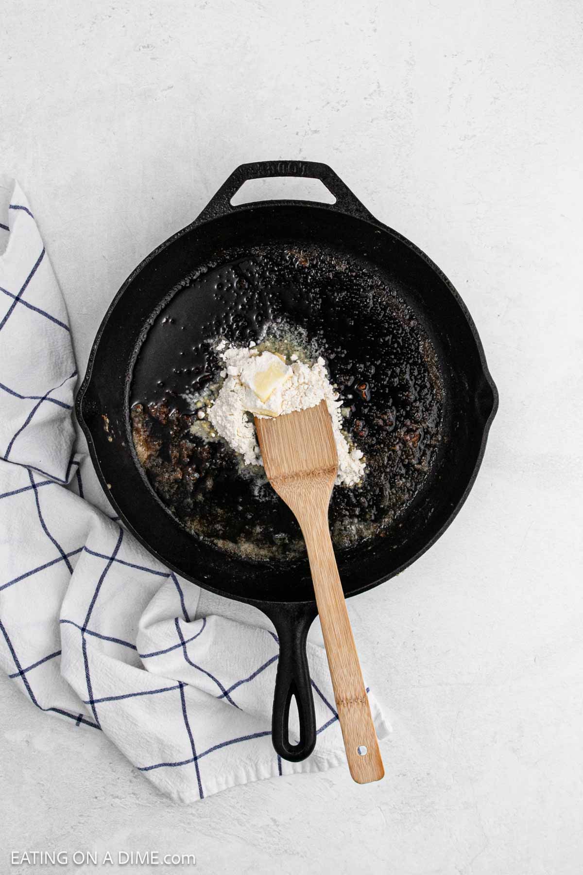 Adding flour and butter in the cast iron skillet.