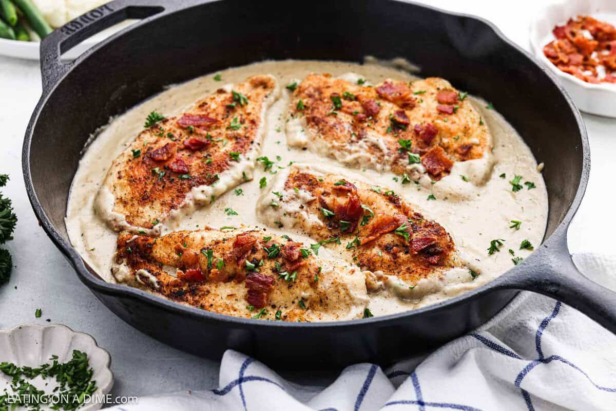 Smothered chicken in a cast iron skillet.