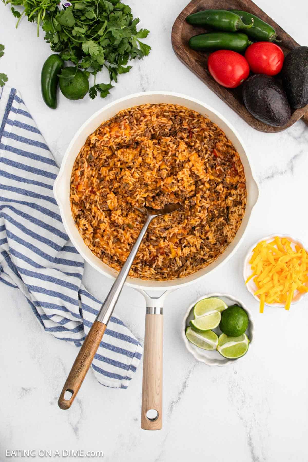 Cooked recipe in the large skillet with a large silver spoon.