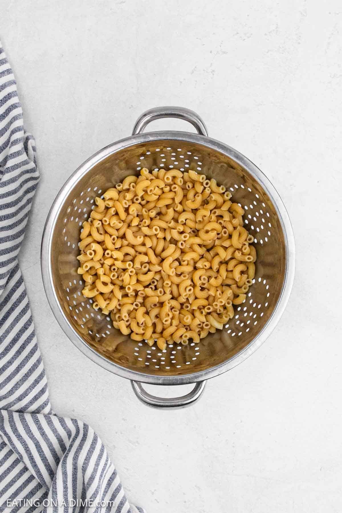 Cooked pasta in a colander.