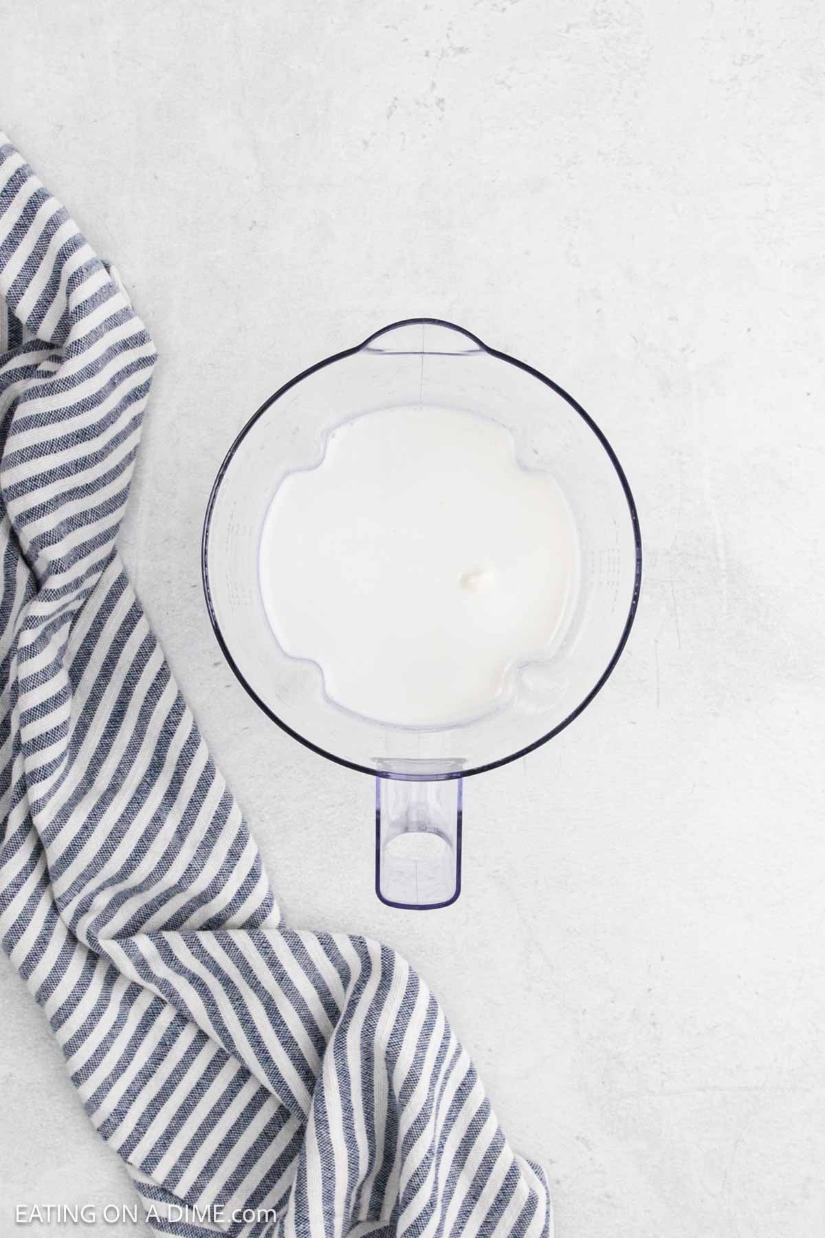 Milk mixture in a clear bowl.