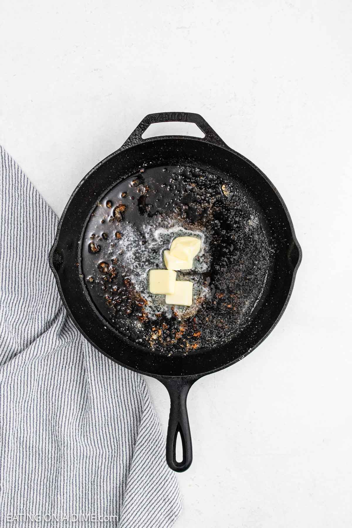 Melting butter in a cast iron skillet.