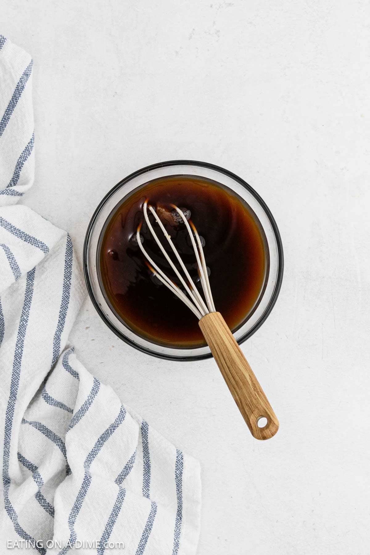 Whisking the gravy ingredients in a bowl.