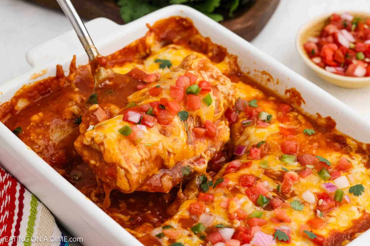 Frozen Burrito Casserole in a baking dish with a spatula ready to serve the casserole.