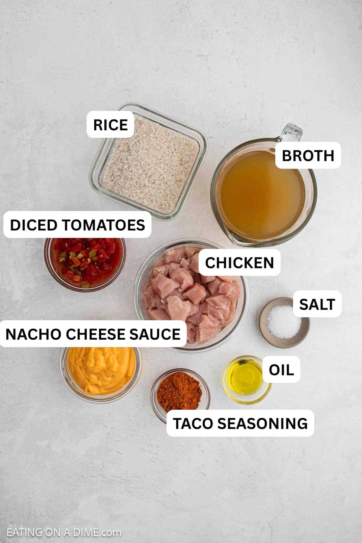 Ingredients needed to make this recipe which includes chicken, oil, taco seasoning, nacho cheese sauce, diced tomatoes, chicken broth, and rice.