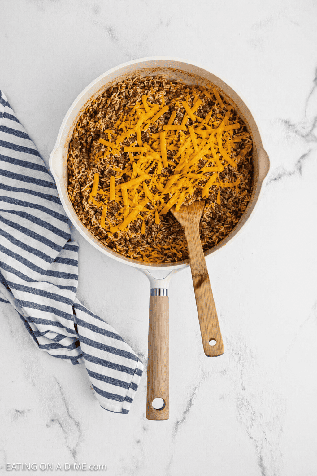Ground beef, rice, shredded cheese in a large skillet.