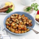 Golden brown breakfast potatoes on a blue plate.