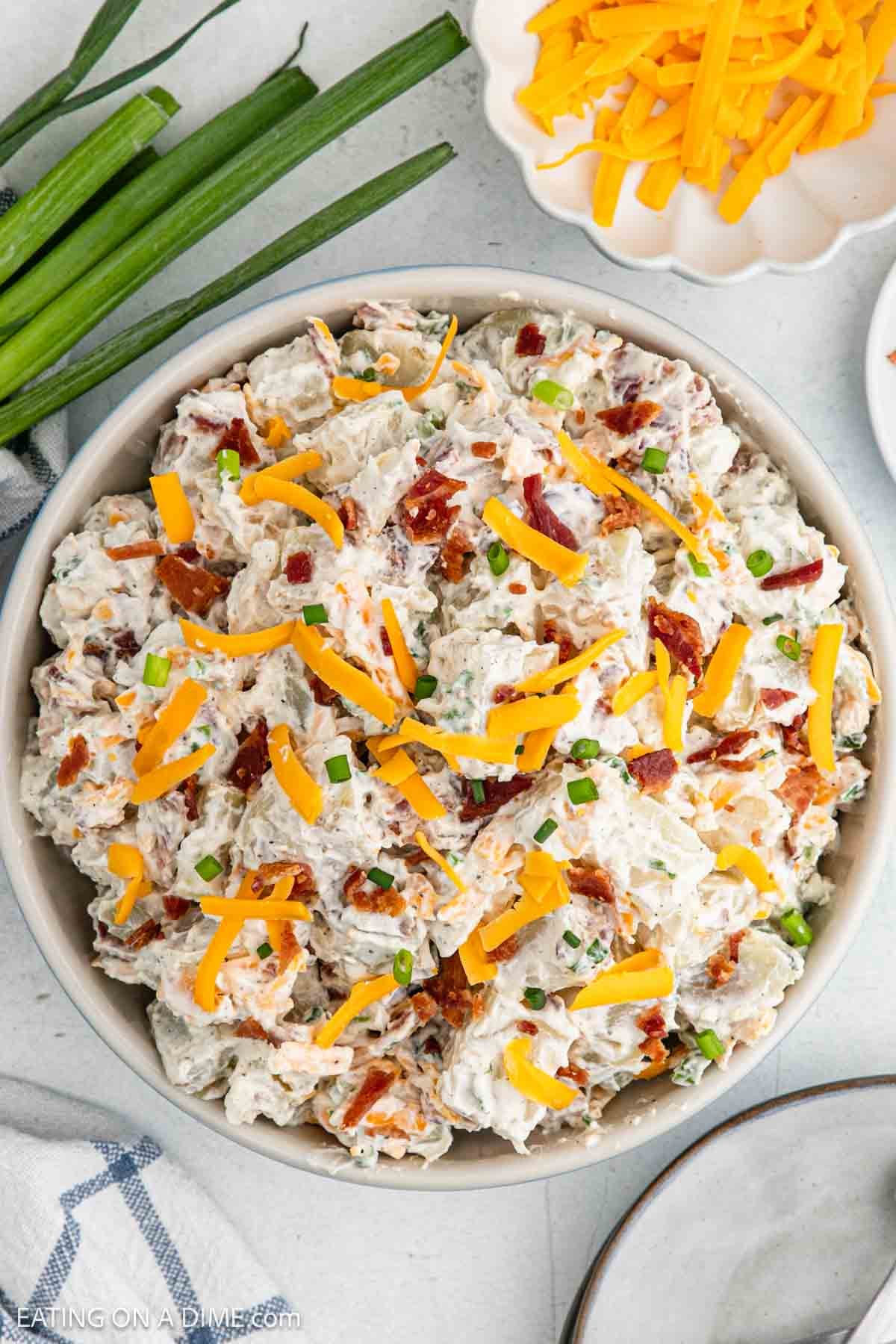 Finished recipe in a bowl topped with shredded cheese.