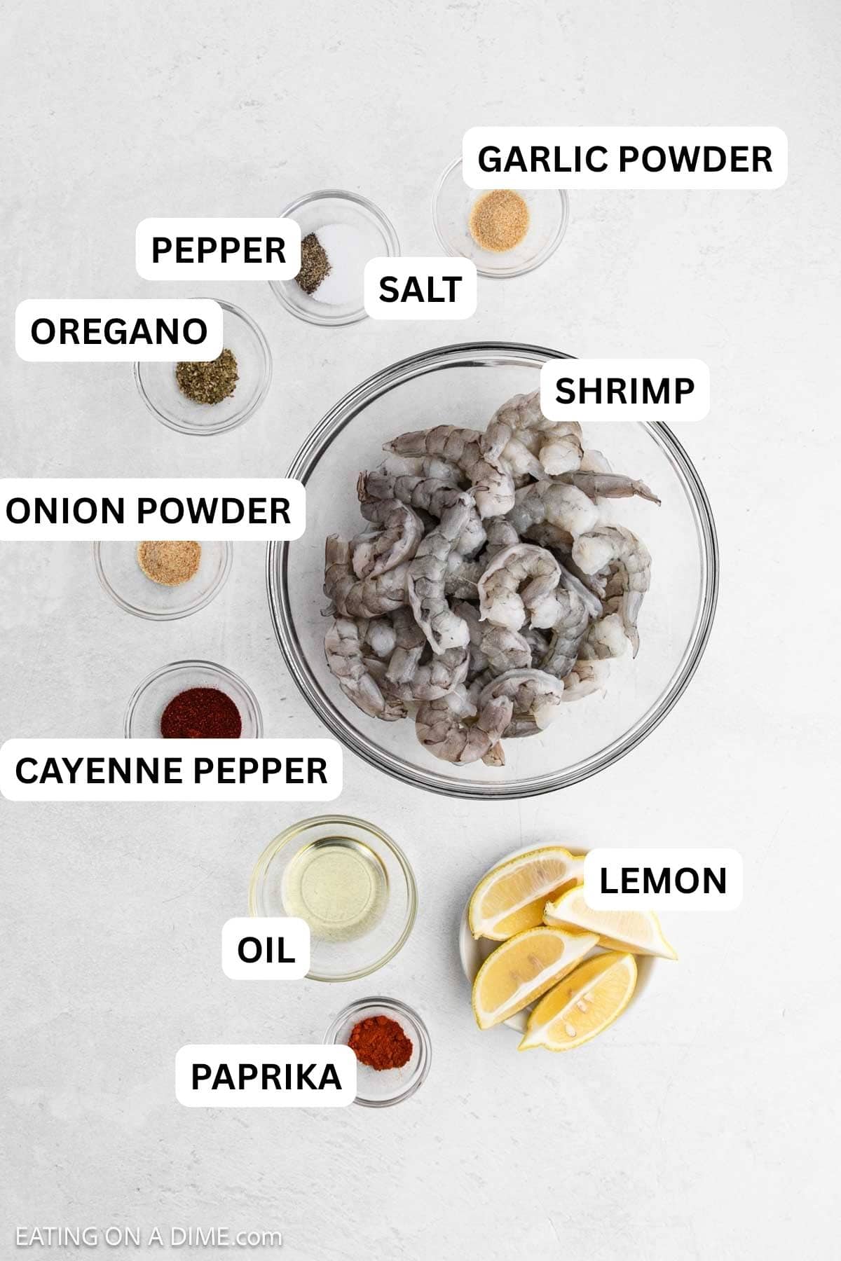 Ingredients needed to make this recipe which includes shrimp, avocado oil, lemon, and spices.