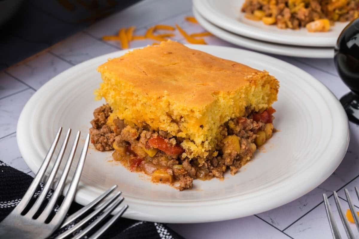 A serving of Cowboy Cornbread Casserole on a white plate. 