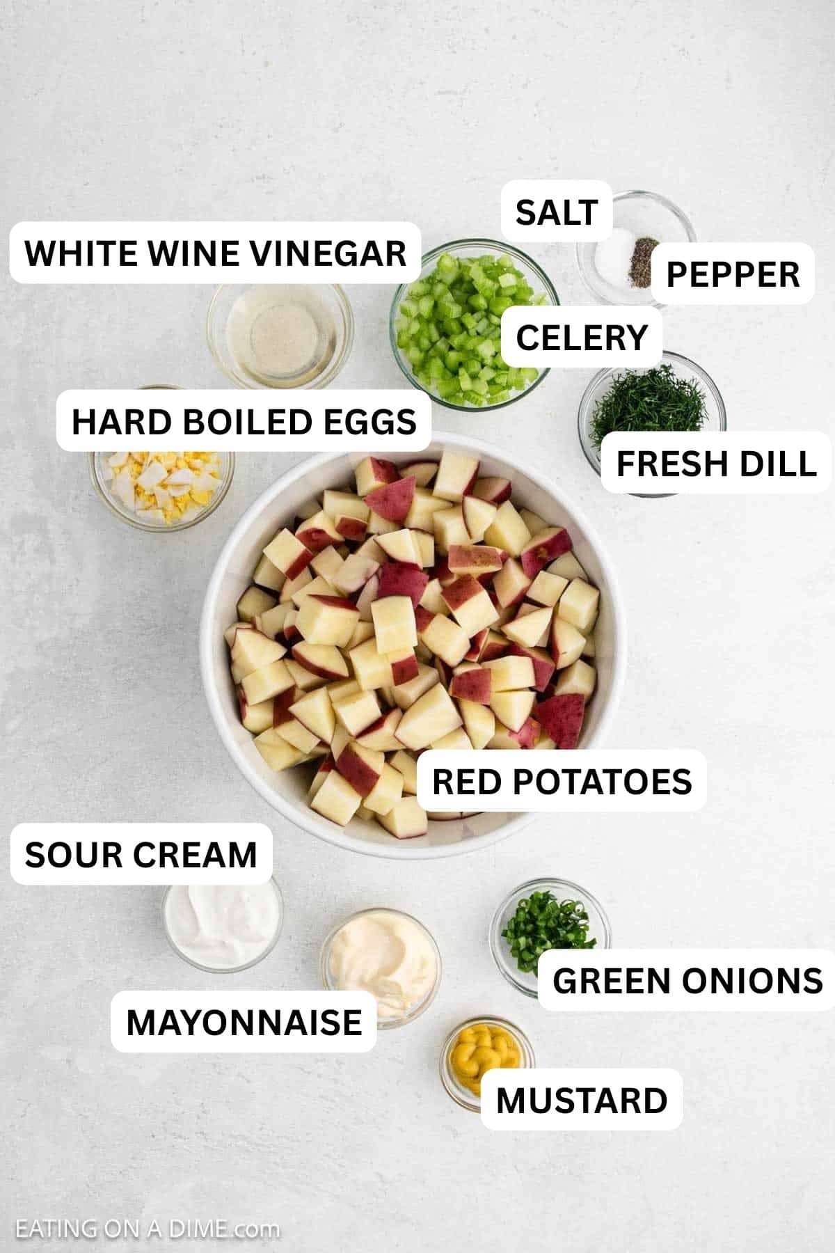 Ingredients needed for this recipe which includes red potatoes, mayonnaise, sour cream, white wine vinegar, yellow mustard, celery, green onion, fresh dill, eggs, salt and pepper.