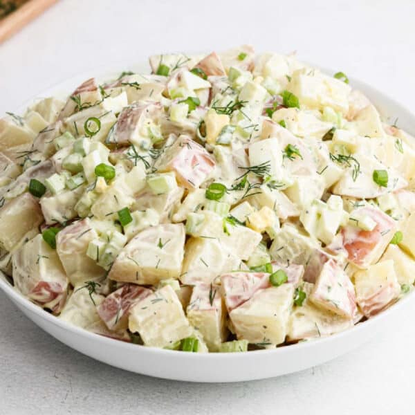 Red potato Salad in a white bowl.