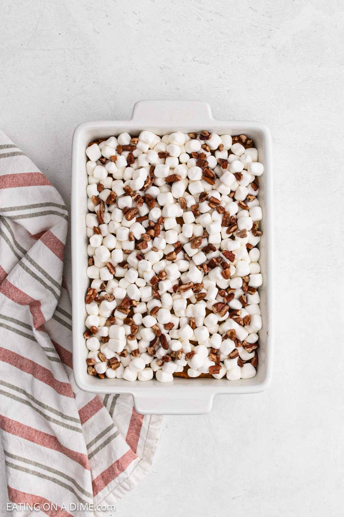 Marshmallow and pecans topped the yams mixture in a baking dish.