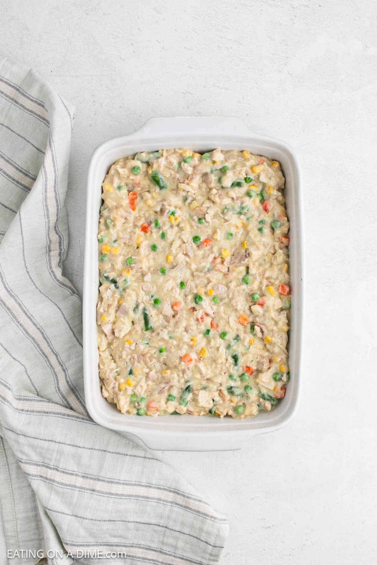 Creamy filling spread into a baking dish.