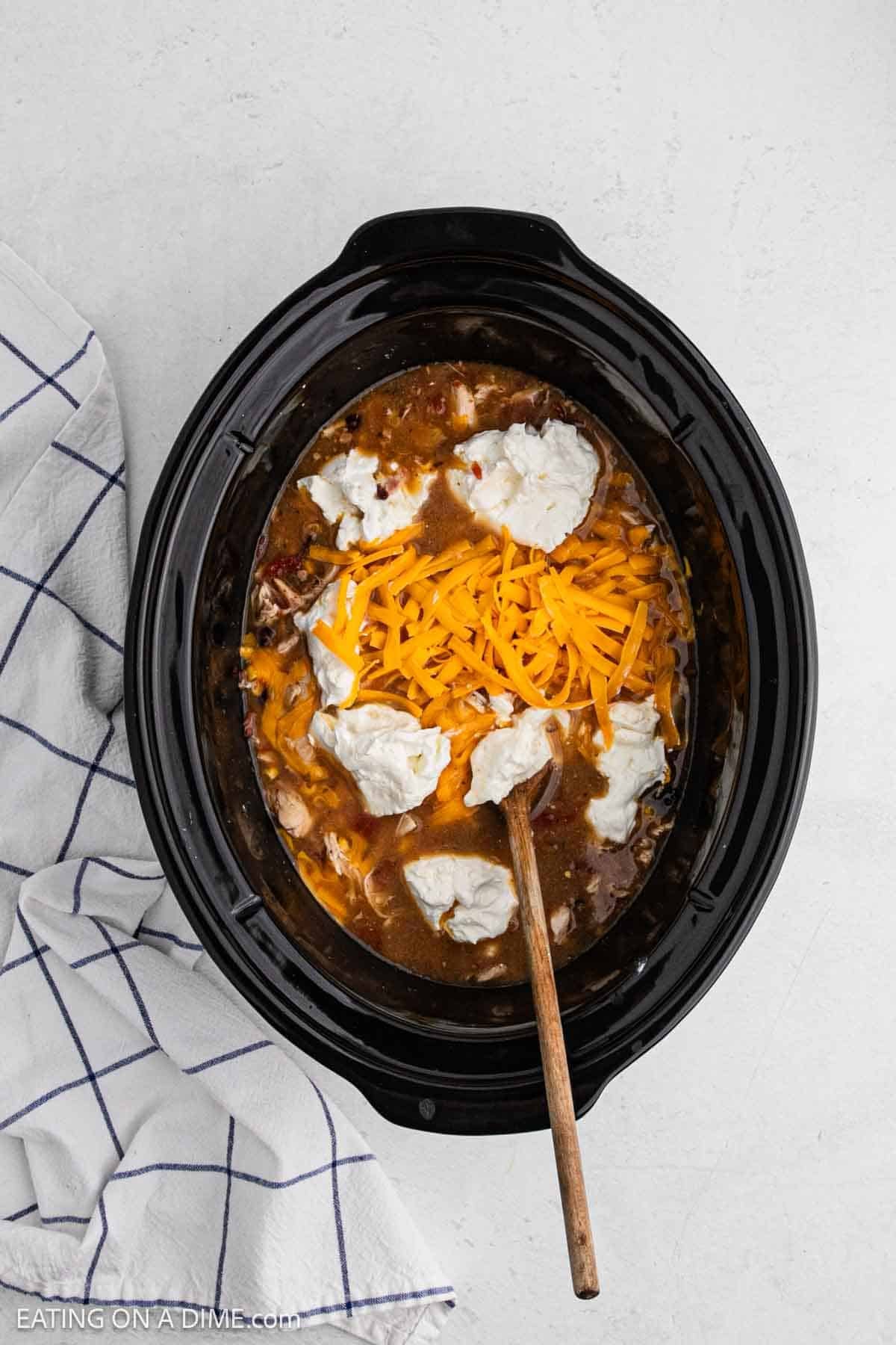 Cream cheese and shredded cheese in the slow cooker with the chili.