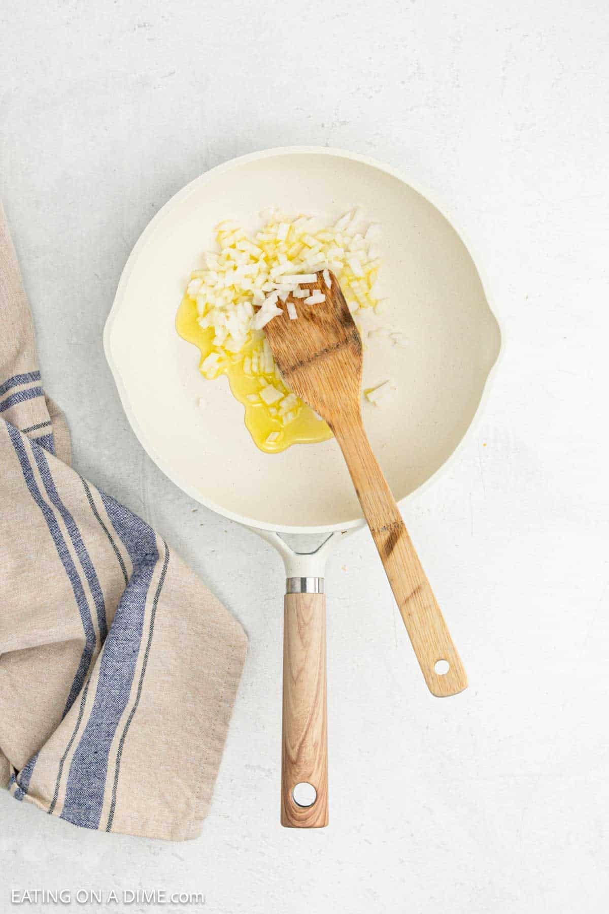 Chopped onions in a skillet with melted butter.