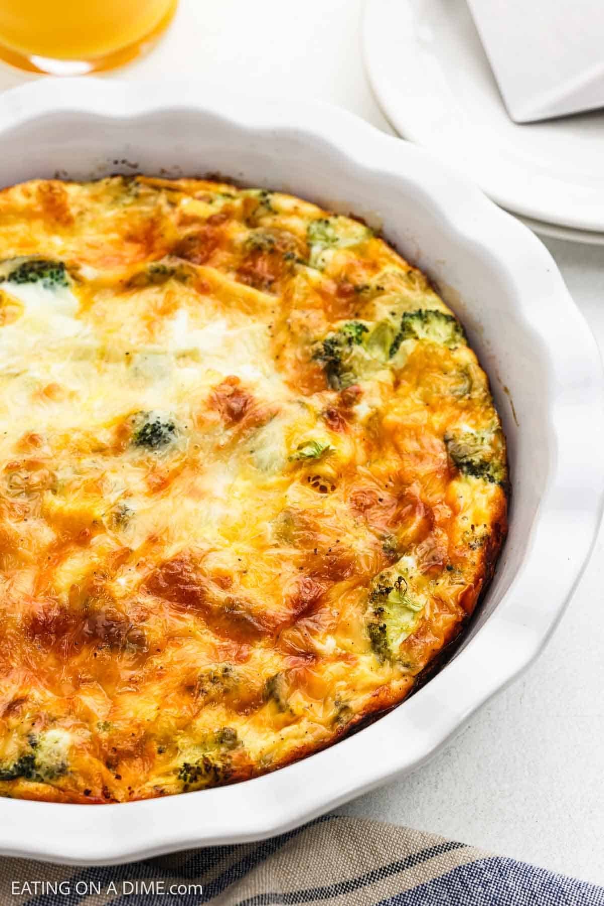 Close up image of baked egg mixture in a pie plate.