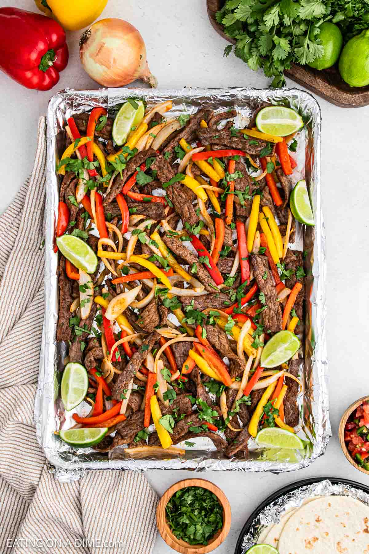 Cooked steak fajitas on a baking sheet.