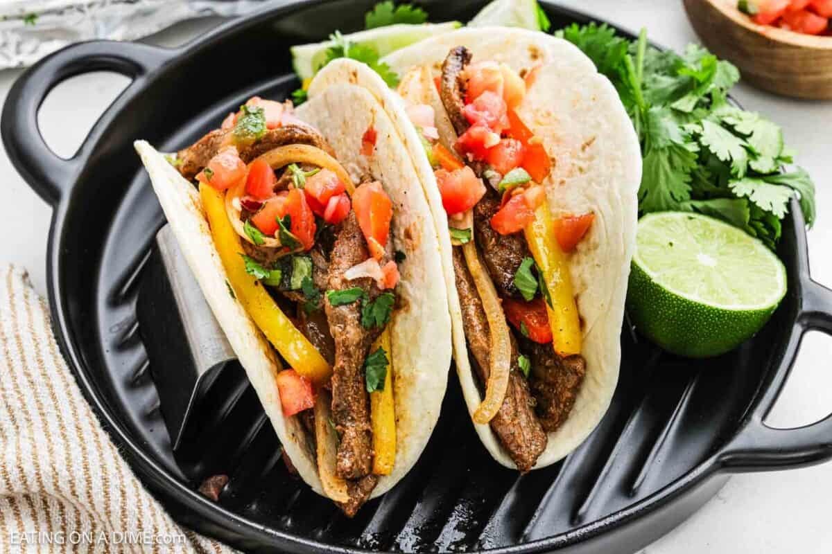 Steak Fajitas in flour tortillas in a large skillet.
